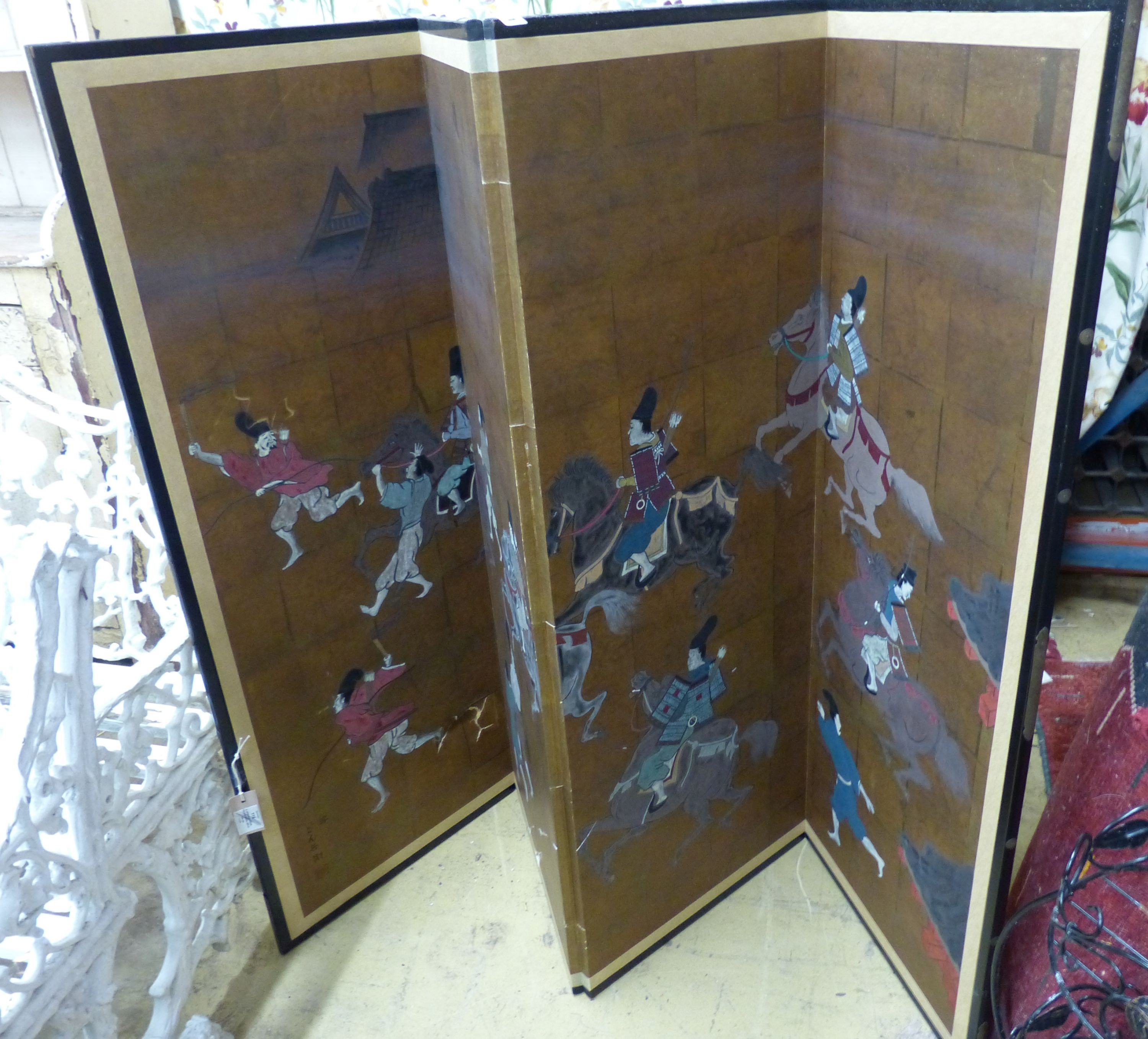 A Japanese four-fold screen, gold ground, decorated with warriors on horseback and foot, in black-lacquered and gilt metal round frame, each panel width 46cm height 122cm